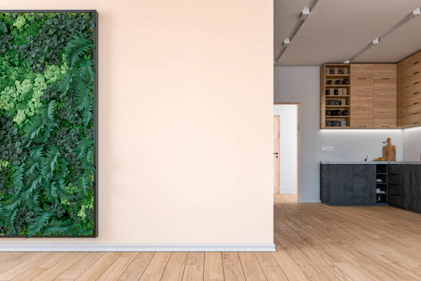 Living room with a vertical garden (green plants wall) lush foliage of potted plants (fern, moss, succulents) in front of a large vanilla/beige colored wall